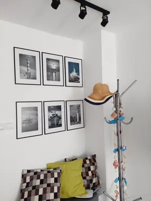 a room with a cowboy hat on a wall with pictures at Апартамент МАРГО in Burgas City