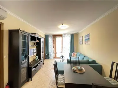 a living room with a blue couch and a television at Sea Bliss Retreat -Santa Marina - Sozopol in Sozopol