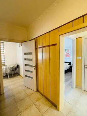 a room with a door and a room with a bedroom at Просторен апартамент in Varna City