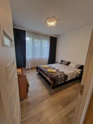 a bedroom with a bed and a window at Просторен апартамент in Varna City