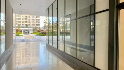 a hallway of a building with glass windows at Arena MALL Galleria View and Securities Parking2 in Burgas City