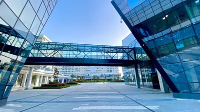 a glass building with a walkway in front of it at Arena MALL Galleria View and Securities Parking2 in Burgas City