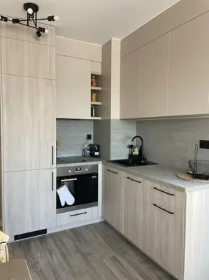a kitchen with white cabinets and a stove top oven at Villi’s Home in Burgas City