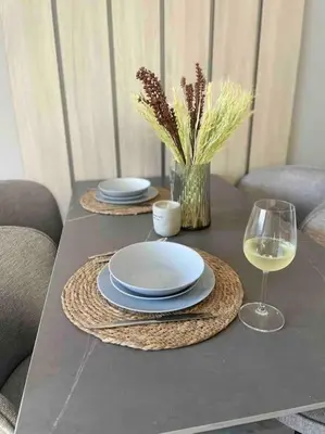 a table with two plates and a glass of wine at Villi’s Home in Burgas City