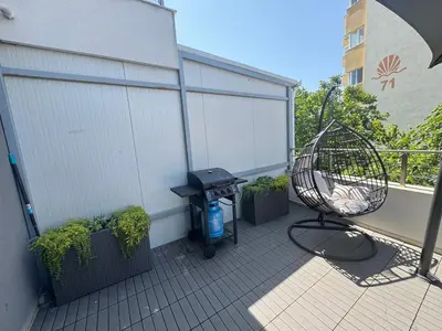 a balcony with a grill and a trash can at Villi’s Home in Burgas City