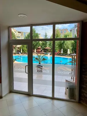 a sliding glass door with a view of a swimming pool at Apartament Esperanza in Sunny Beach