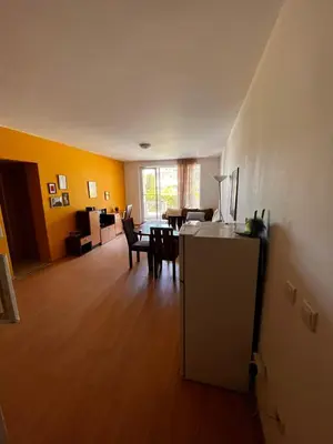 an empty living room with a table and chairs at Sozopolis Hills - B1 - 3-room apart - 10 min from the beach in Sozopol