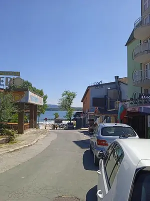 a street with cars parked on the side of a beach at APARTMENT 8 Primorsko АПАРТАМЕНТ 8 Приморско in Primorsko