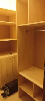 a closet with wooden shelves and a bag at Cozy apartment with sea view and free parking in Pomorie