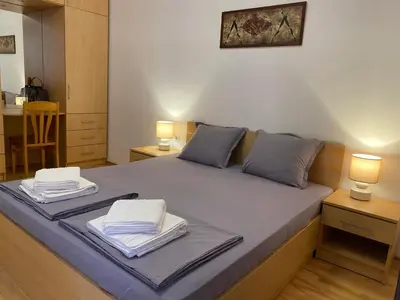 a bedroom with a bed with two towels on it at Harmani Beach Apartment 4 in Sozopol