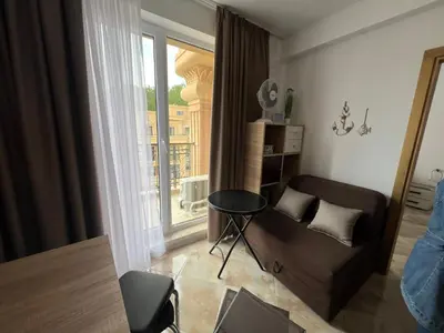 a living room with a couch and a window at Aphrodite Park in Sunny Beach