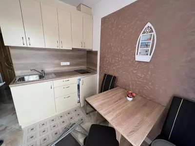a small kitchen with a wooden table and a sink at Aphrodite Park in Sunny Beach