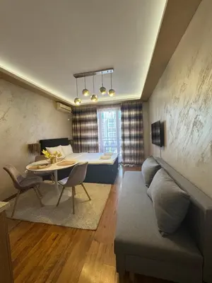a living room with a couch and a table at MitProt Panorama Bay 2 Luks studio 155 in Sveti Vlas