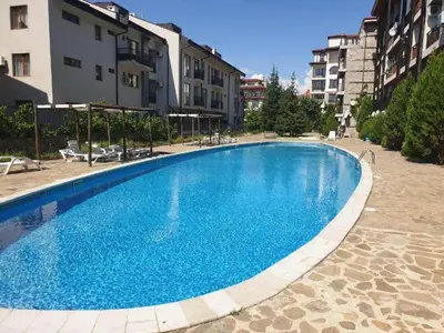 a large blue swimming pool next to some buildings at MitProt Panorama Bay 2 Luks studio 155 in Sveti Vlas