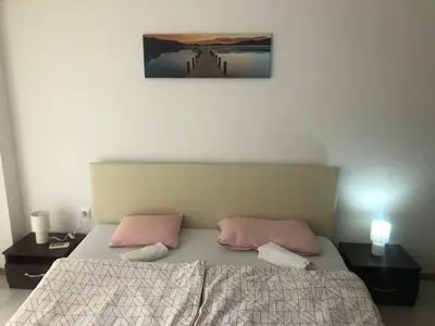 a bedroom with a bed with two pink pillows at Lovely 3 Room Apartment new furnished Kamelia Sunny Beach in Sunny Beach
