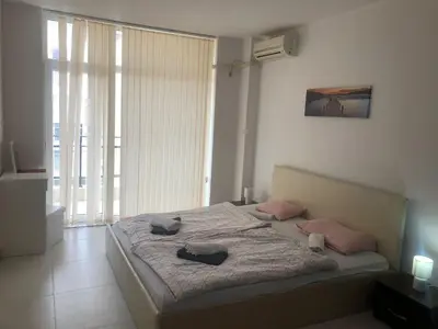 a bedroom with a large bed with pink pillows at Lovely 3 Room Apartment new furnished Kamelia Sunny Beach in Sunny Beach