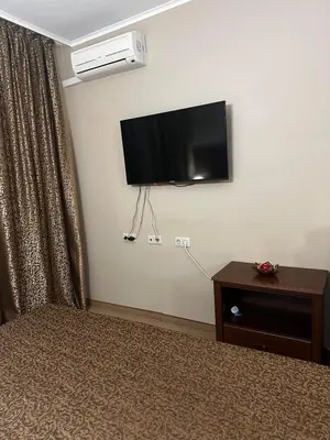 a room with a bed and a flat screen tv on a wall at Studio Festa Pomorie in Pomorie