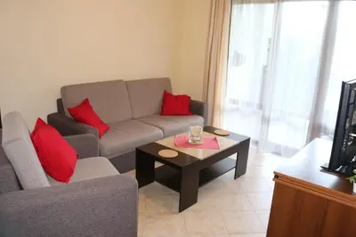 a living room with a couch and a coffee table at 1 bedroom apartment in Santa Marina Sozopol in Sozopol