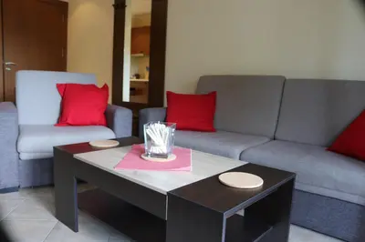 a living room with a couch and a coffee table at 1 bedroom apartment in Santa Marina Sozopol in Sozopol