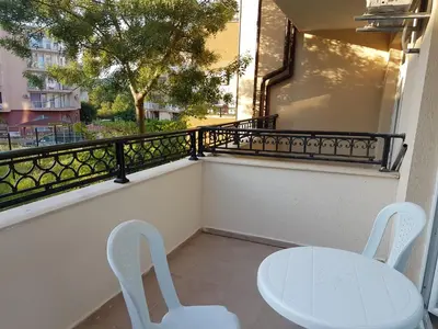 a white table and two chairs on a balcony at Apartament Iglika in Primorsko