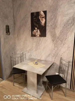 a table with two chairs and a picture on the wall at MitProt Panorama Bay 2 Studio 206 in Sveti Vlas
