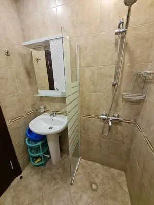 a bathroom with a sink and a shower with a mirror at MitProt Panorama Bay 2 Studio 206 in Sveti Vlas