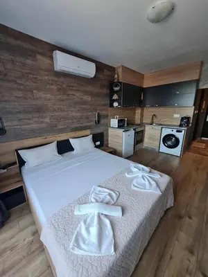a bedroom with a bed with towels on it at MitProt Panorama Bay 2 Studio 206 in Sveti Vlas