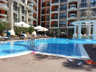 a large swimming pool in front of a building at Harmony Palace - Menada Apatments in Sunny Beach