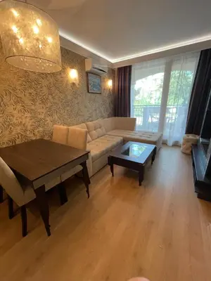 a living room with a couch and a table at Harmony Palace - Menada Apatments in Sunny Beach