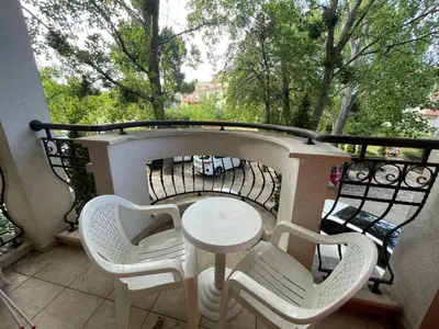 a small table and chairs on a balcony at Harmony Palace - Menada Apatments in Sunny Beach