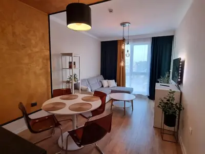 a living room with a table and chairs and a couch at Golden leaf, swimming pool view in Ravda