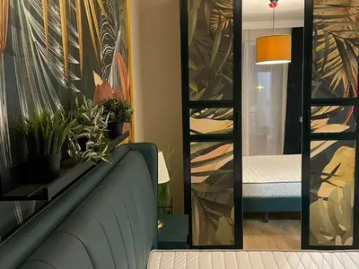 a living room with a couch and a mirror at Golden leaf, swimming pool view in Ravda