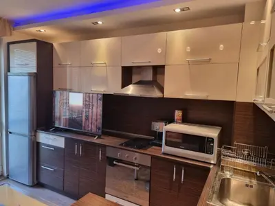a kitchen with a microwave on a counter at Апартамент Ломбарди in Varna City
