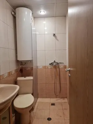 a bathroom with a shower and a toilet and a sink at Апартамент Ломбарди in Varna City