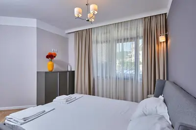 a bedroom with a white bed and a window at Florance Rentals Luxury Apartments in Saint Vlas in Sveti Vlas