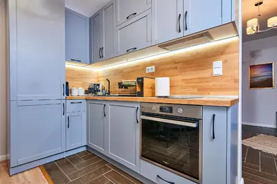 a kitchen with white cabinets and an oven at Florance Rentals Luxury Apartments in Saint Vlas in Sveti Vlas