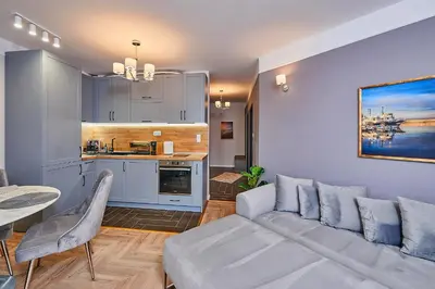 a living room with a couch and a kitchen at Florance Rentals Luxury Apartments in Saint Vlas in Sveti Vlas