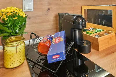 a coffee maker and a box of food on a counter at Florance Rentals Luxury Apartments in Saint Vlas in Sveti Vlas