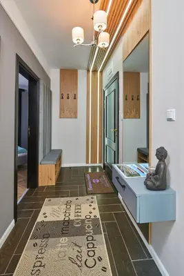a room with a table and a statue on the floor at Florance Rentals Luxury Apartments in Saint Vlas in Sveti Vlas