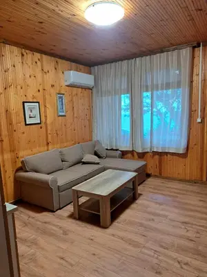 a living room with a couch and a coffee table at Комплекс Джулай Морнинг in Kiten