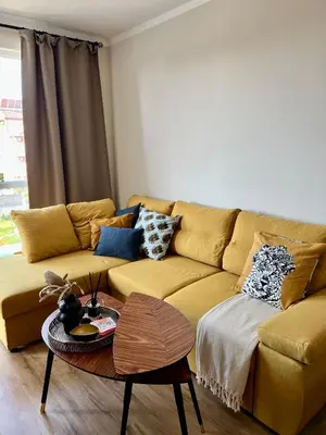 a living room with a couch and a table at Sunny apartment in Bellicity complex in Ravda