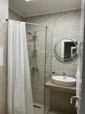 a bathroom with a shower and a sink and a mirror at Sunny apartment in Bellicity complex in Ravda