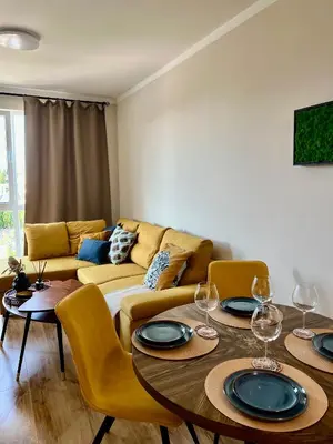 a living room with two tables and a couch at Sunny apartment in Bellicity complex in Ravda