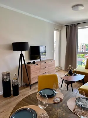 a living room with a table with wine glasses on it at Sunny apartment in Bellicity complex in Ravda
