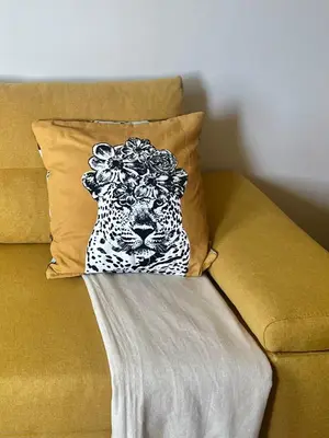 a pillow with a leopard head sitting on a couch at Sunny apartment in Bellicity complex in Ravda