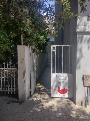 a gate with a sign on it next to a building at ЛИДЕР ХАУС ХОСТЕЛ in Varna City