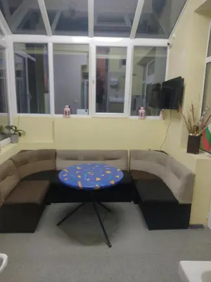 a living room with a couch and a table at ЛИДЕР ХАУС ХОСТЕЛ in Varna City