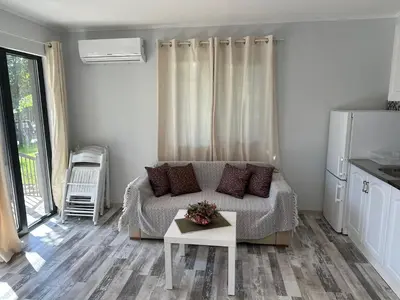 a living room with a couch and a table at Villa Sea House in Byala