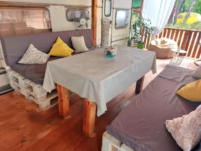 a table and a couch in a living room at Каравана Summer time in Chernomorets