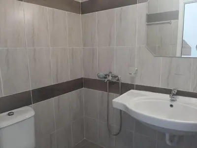 a bathroom with a sink and a toilet at Апартаменти Жени in Tsarevo